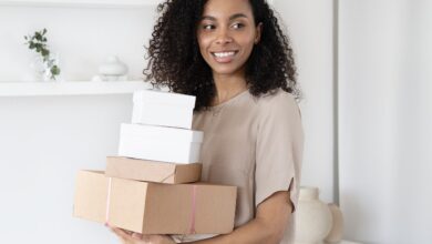 small business owner woman carrying packaging boxes